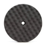 A Starke Double Sided Quick-Connect Black Foam Finishing Pad with a hexagonal hole in the center, designed for use with polishing machines.