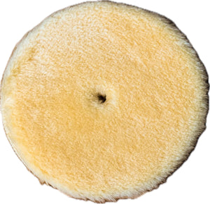 Close-up of a yellow wool polishing pad, designed for use with rotary polishers, ideal for heavy cutting and removing oxidation on gel coat and painted surfaces.