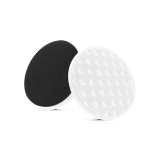 Black and white dual-sided polishing pad, with one side smooth and the other featuring raised dots, designed for finishing and polishing applications.