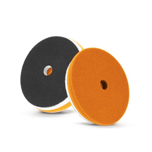 Dual-sided yellow and black foam polishing pad for polishing and finishing surfaces.
