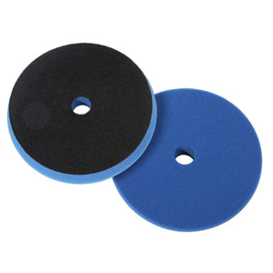 Two foam polishing pads with central holes, one black and the other blue, stacked side by side.